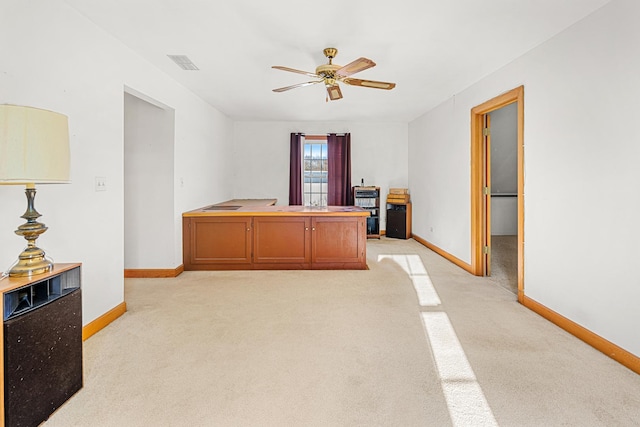 carpeted office featuring ceiling fan