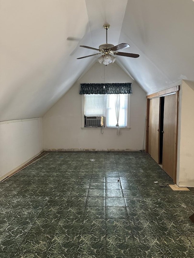 additional living space with ceiling fan, cooling unit, and vaulted ceiling