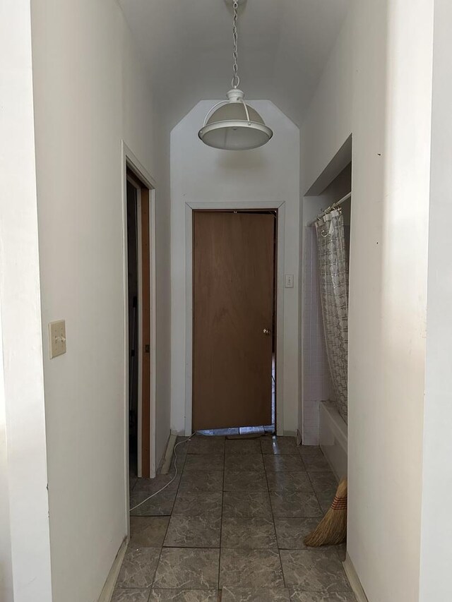 stairway with tile walls and wood-type flooring