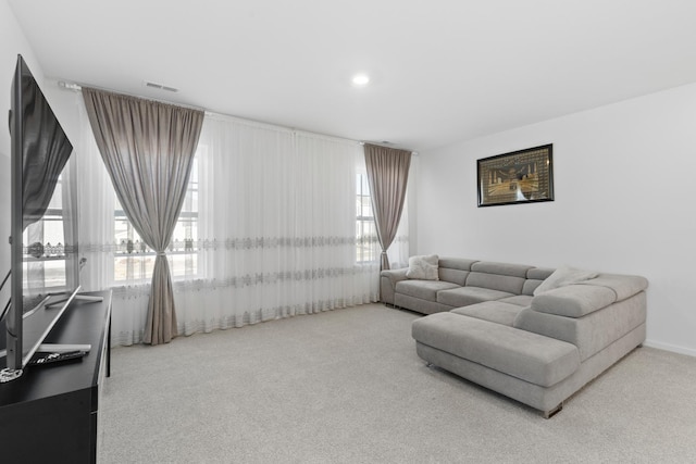 carpeted living room featuring plenty of natural light