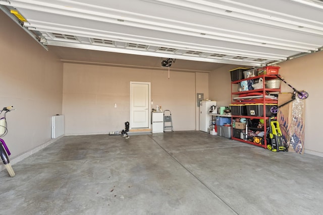 garage featuring a garage door opener and water heater