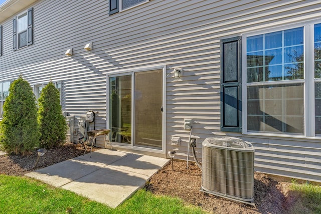 doorway to property with a patio and central AC unit