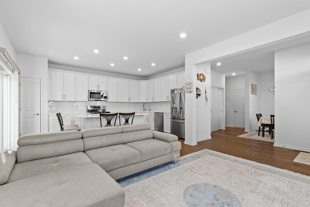 living room featuring sink and light wood-type flooring