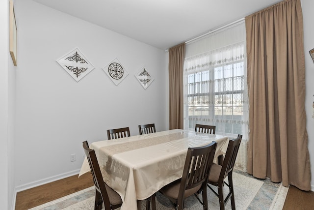 dining space with light hardwood / wood-style floors