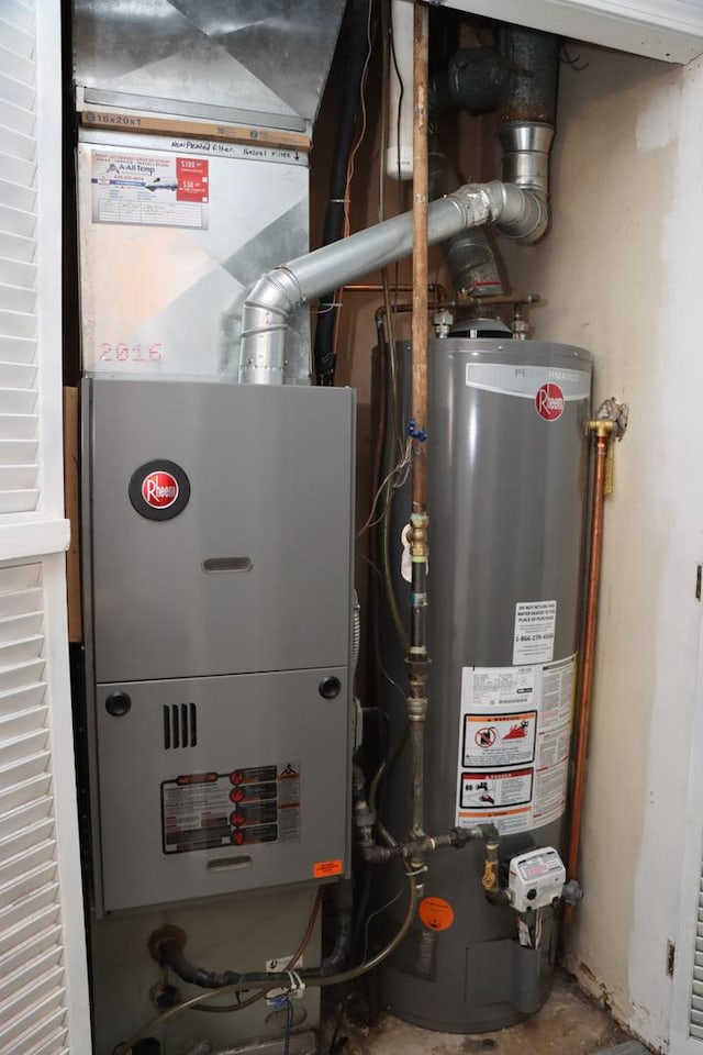 utility room with heating unit and water heater