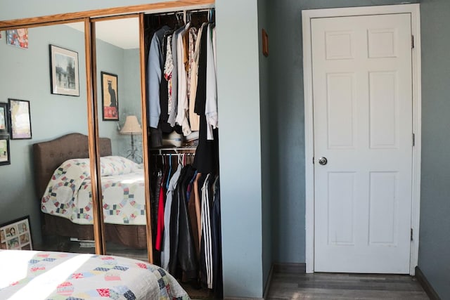 bedroom with a closet and dark wood-type flooring