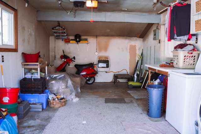 garage featuring electric panel and washer / dryer