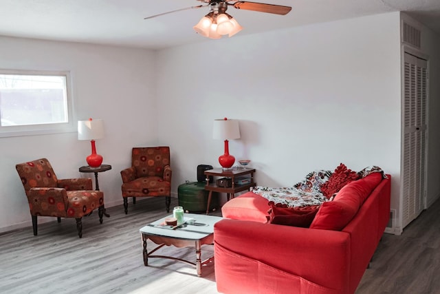 living room featuring hardwood / wood-style floors and ceiling fan