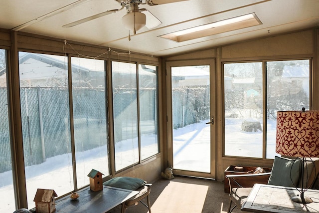 sunroom featuring ceiling fan and lofted ceiling