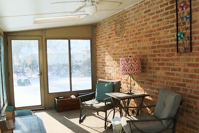 sunroom featuring ceiling fan and lofted ceiling