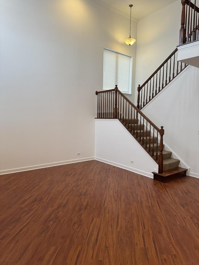 interior space featuring dark wood-type flooring and a high ceiling