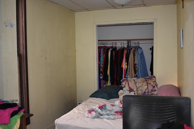 bedroom featuring a closet and a drop ceiling