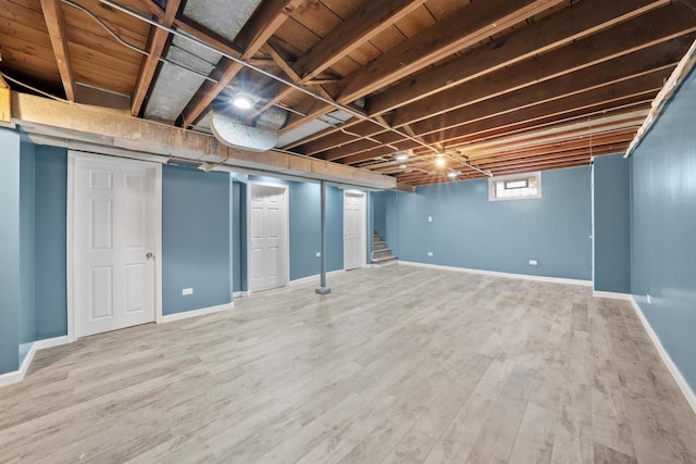 basement with hardwood / wood-style floors