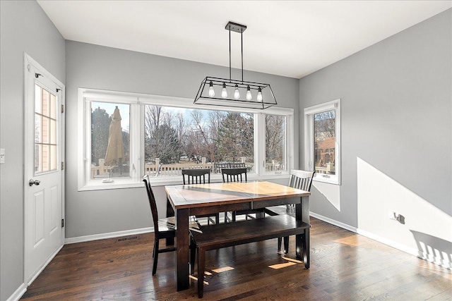 dining area with dark hardwood / wood-style flooring