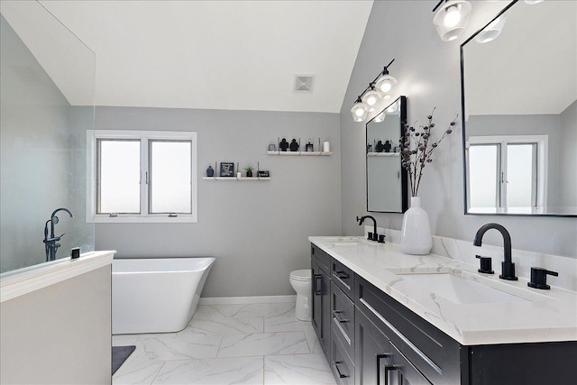 bathroom with a tub to relax in, lofted ceiling, toilet, and vanity