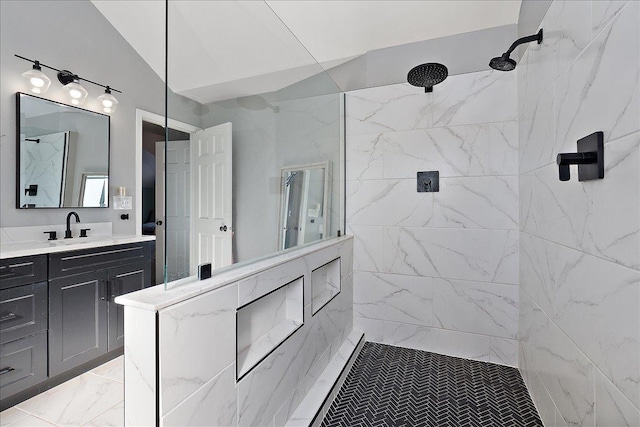 bathroom with vanity, vaulted ceiling, and a tile shower