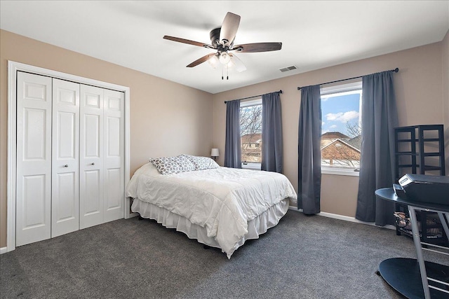 carpeted bedroom featuring a closet and ceiling fan