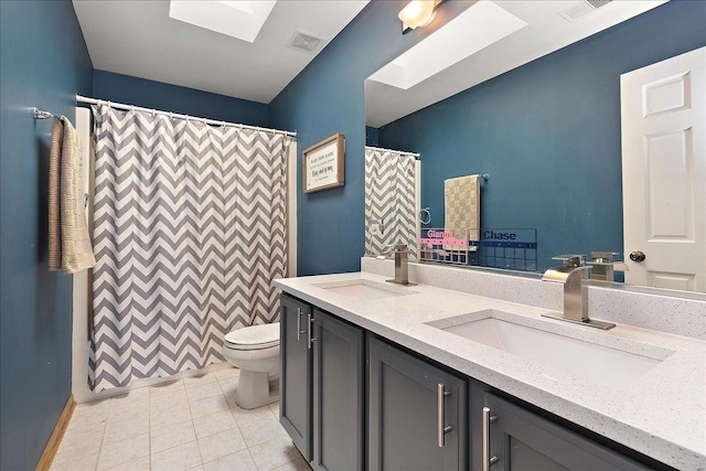 bathroom with a skylight, tile patterned flooring, vanity, toilet, and a shower with shower curtain