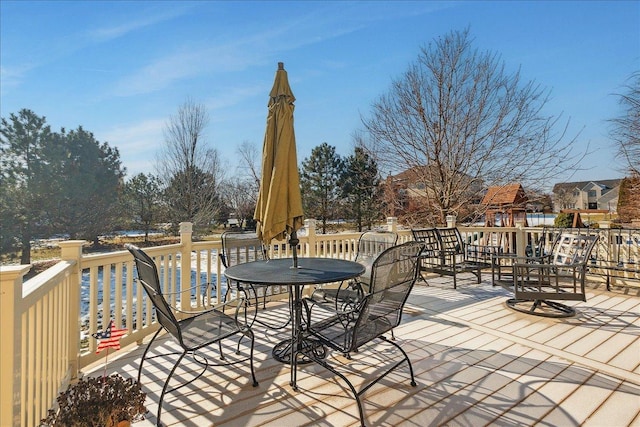 wooden terrace with a playground and a water view