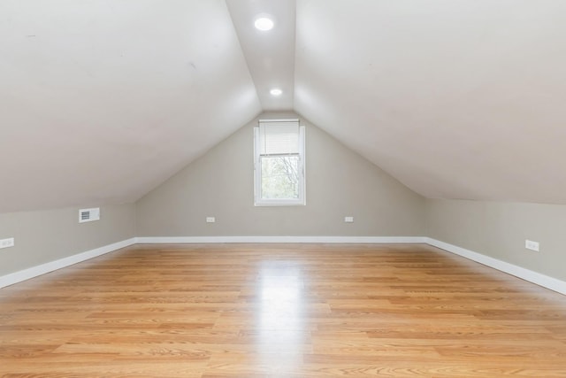 bonus room featuring light hardwood / wood-style floors and lofted ceiling