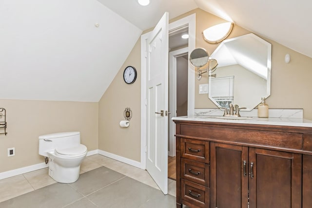 bathroom featuring tile patterned floors, vanity, vaulted ceiling, and toilet