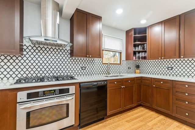 kitchen with decorative backsplash, light wood-type flooring, stainless steel appliances, sink, and wall chimney range hood