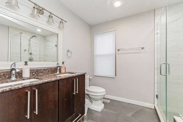 bathroom with vanity, toilet, and an enclosed shower