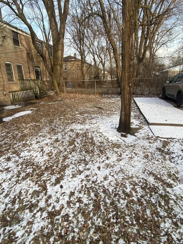 view of yard layered in snow