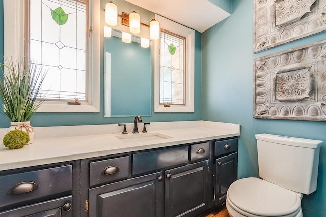 bathroom featuring toilet and vanity