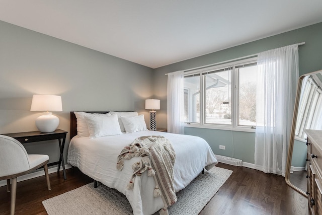 bedroom with dark hardwood / wood-style floors