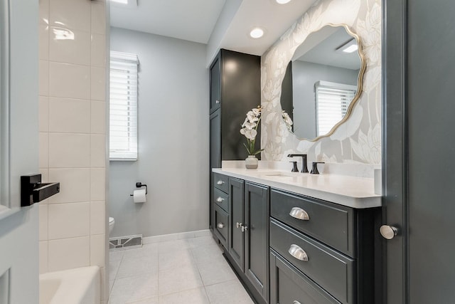 bathroom featuring toilet, vanity, a bath, and tile patterned flooring