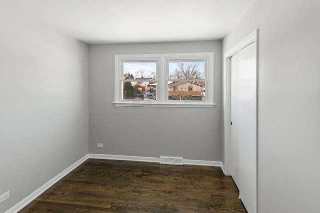 spare room featuring dark hardwood / wood-style floors