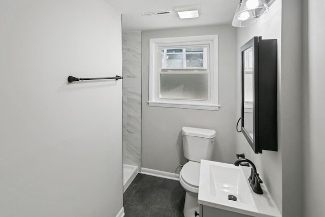 bathroom with walk in shower, vanity, and toilet