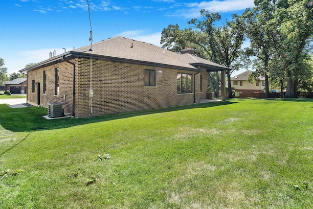 view of property exterior featuring a yard and central air condition unit