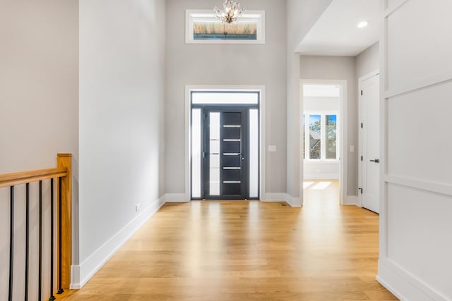 foyer with an inviting chandelier and light hardwood / wood-style floors