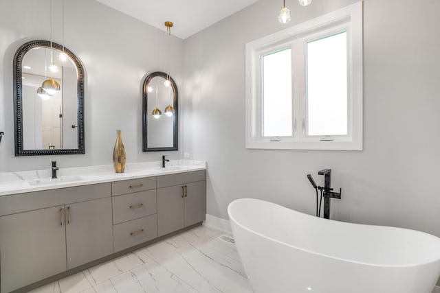 bathroom featuring a tub to relax in and vanity