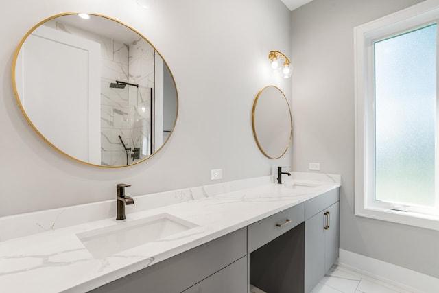 bathroom with vanity and tiled shower