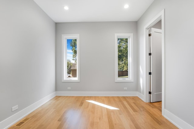 empty room with light hardwood / wood-style flooring