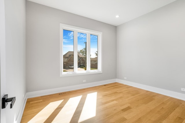 spare room with light wood-type flooring