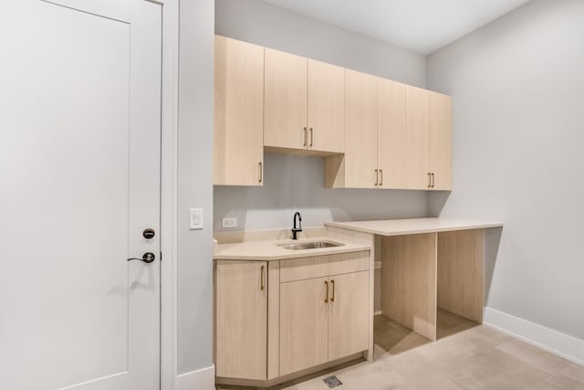 kitchen with sink and light brown cabinetry