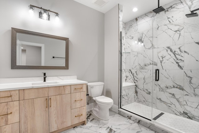 bathroom featuring toilet, a shower with door, and vanity