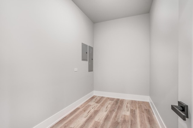 clothes washing area featuring light hardwood / wood-style floors and electric panel