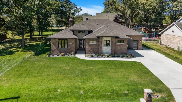 view of front of home featuring a front yard and a garage