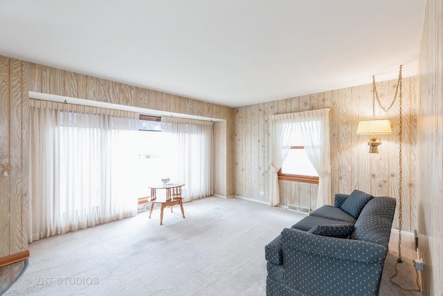 sitting room with a wealth of natural light and carpet flooring