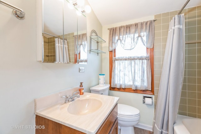 full bathroom with vanity, toilet, and shower / bath combo with shower curtain