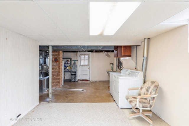 basement featuring washer and dryer and a paneled ceiling