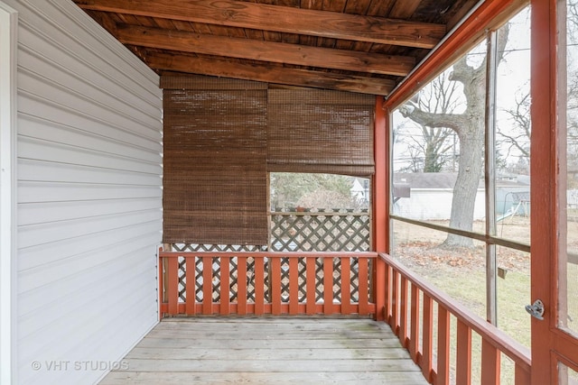 unfurnished sunroom with beamed ceiling and wooden ceiling