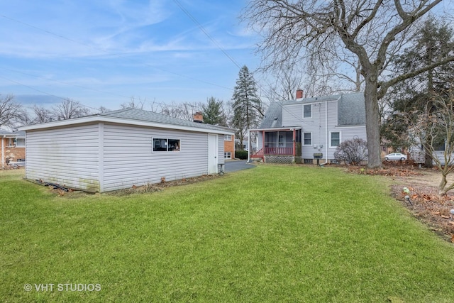 rear view of property with a lawn