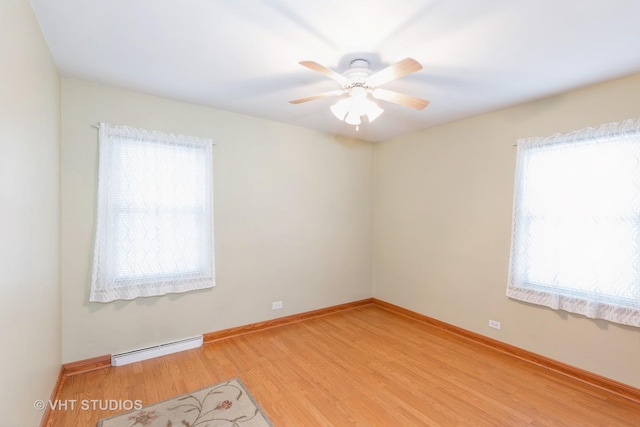 spare room featuring ceiling fan, a baseboard radiator, and light hardwood / wood-style floors