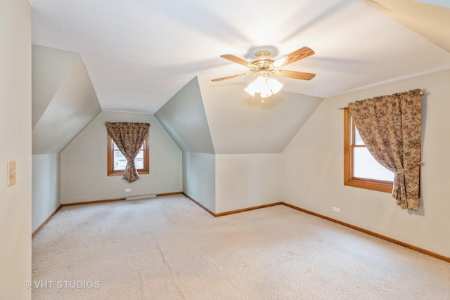 bonus room with lofted ceiling, light colored carpet, and ceiling fan